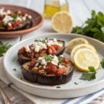 Served Mediterranean baked eggplant with tomato and feta