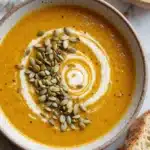 served autumn squash soup with toppings