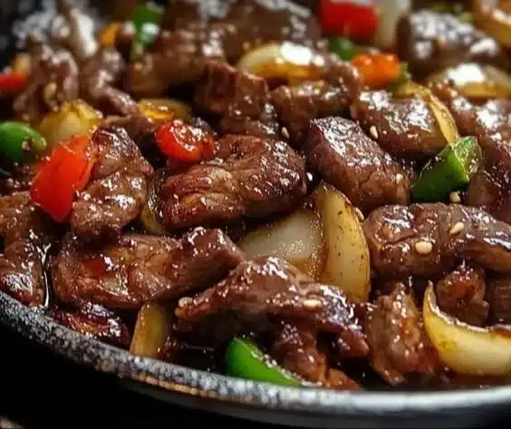 Sizzling Chinese pepper steak with onions served on a plate
