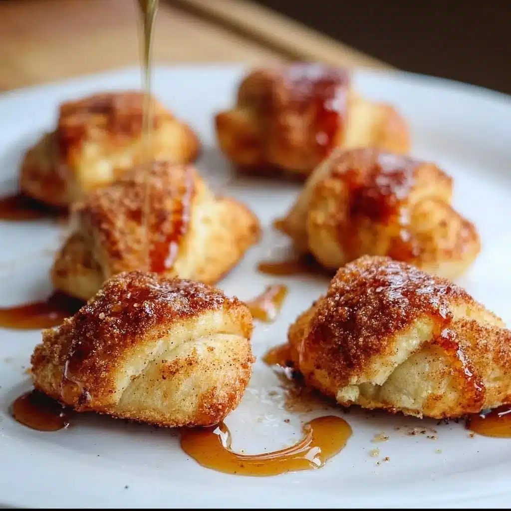Delicious apple pie bites served on a plate, garnished with caramel sauce.