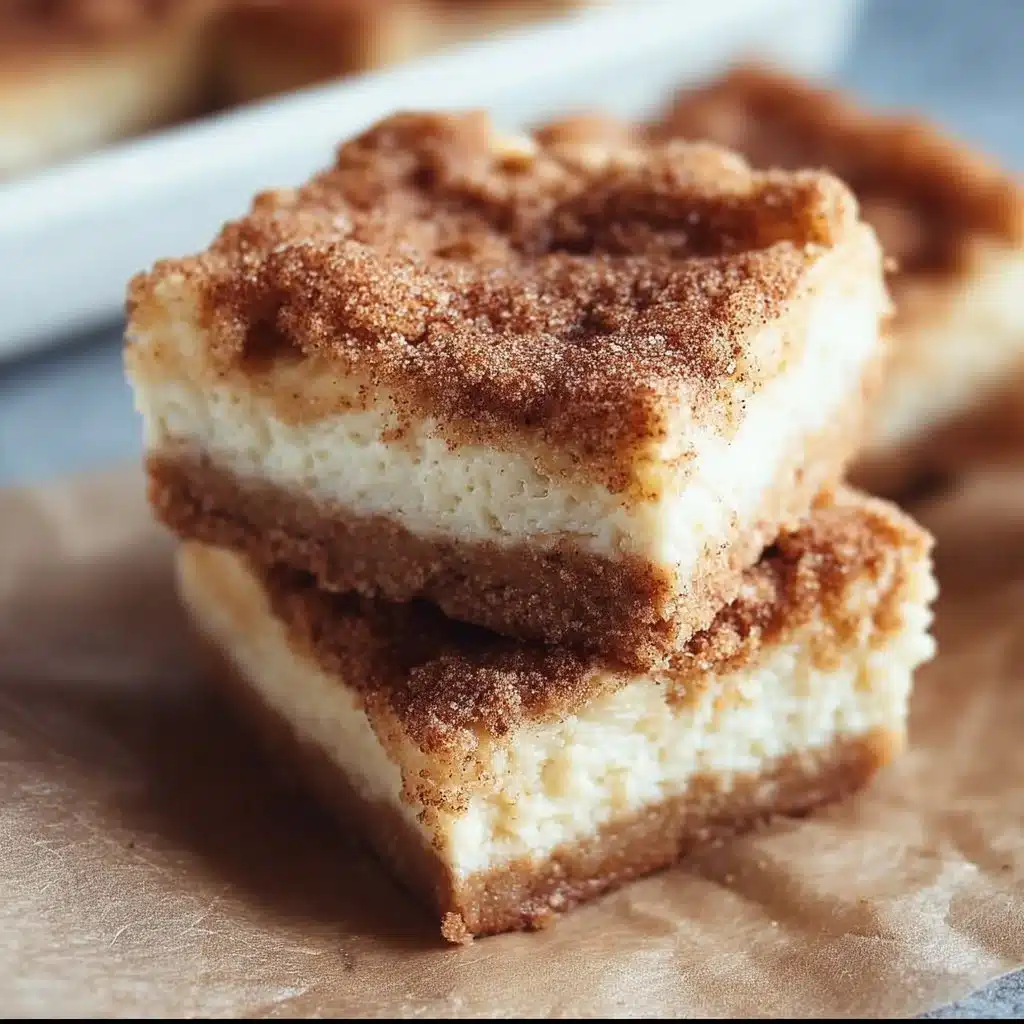 Delicious snickerdoodle cheesecake bars topped with cinnamon sugar