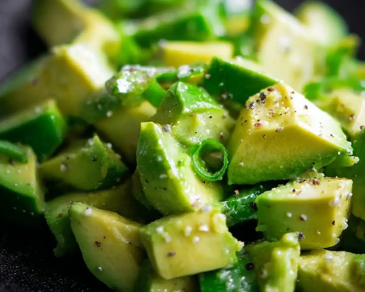 Fresh and colorful easy avocado salad with mixed vegetables and dressing.