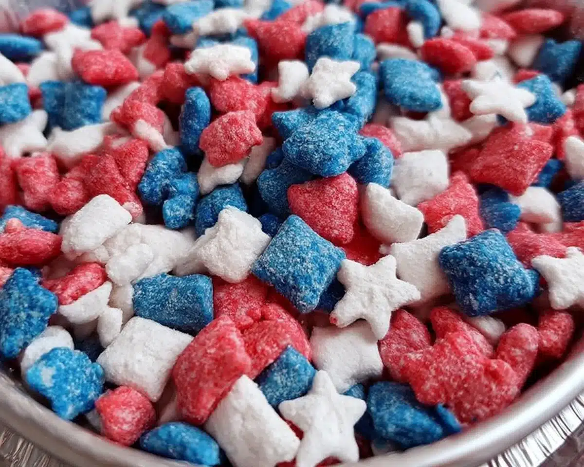 Patriotic Muddy Buddies snack mix with red, white, and blue colors for celebrations